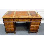 A late 19th century figured walnut writing desk with nine drawers about the knee,