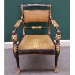 A Regency ebonised parcel gilt open arm chair raised on a pair of lion monopodia,