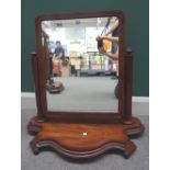 An early Victorian mahogany swing frame toilet mirror on octagonal columns and shaped base,