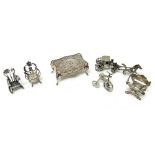 A collection of mostly silver miniature items, comprising; a shaped rectangular table,