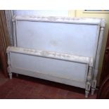 An early 20th century French white painted double bed, with fluted and reeded columns,