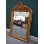 A Victorian gilt framed wall mirror with opposing 'C' scroll crest and floral moulded frame,