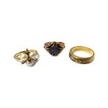 A gold and sapphire single stone ring, a 9ct gold and diamond three stone ring and a 9ct gold,