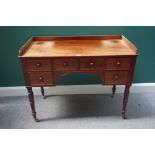 A Victorian mahogany writing table with six drawers about the knee, on turned supports,