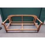 A Victorian hump-back sofa frame on turned mahogany supports, 205cm wide x 79cm high.