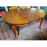 A late 19th century French circular fruitwood extending dining table, on cabriole supports,