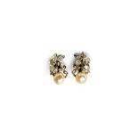 A pair of diamond and cultured pearl set earclips, each designed as a foliate scrolling spray,