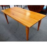 A 19th century style French fruitwood plank top kitchen table, on tapering square supports,