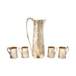 A silver and gilt five piece drinks set, decorated with flowers emblematic of the seasons,