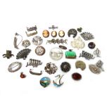 A group of thirty-five brooches and eight stick pins, in a variety of designs,