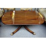 A George III style mahogany coffee table, the rounded rectangular top on four downswept supports,