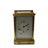 A brass cased carriage clock, early 20th century, with visible escapement,