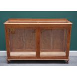 A 20th century oak framed display cabinet with glazed top and sides about a central pair of doors