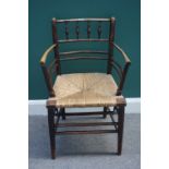 A Victorian oak and stained beech William Morris Sussex chair, with rush seat and turned supports,