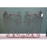 A pair of mid 20th century French wrought iron gates with acanthus scroll decoration and wall