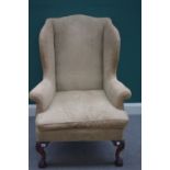 A George I style wingback armchair, on cabriole supports and claw and ball feet,