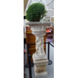 A reconstituted stone jardiniere, with lattice body, on a cherub column and shaped square base,