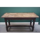 A made-up 17th century oak plank top refectory table on baluster turned supports united by 'H'