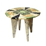 Hilda Hellstrom; a circular marble veneered table, on four triangular supports,