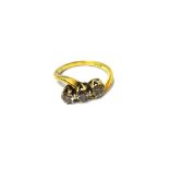 An 18ct gold and diamond set three stone ring,