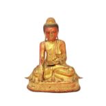 A large red painted and gilt bronze figure of Buddha,