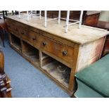 A large 19th century pine dresser base with three frieze drawers over pair of cupboards,