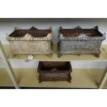 A set of three Victorian cast iron rectangular planters, with floral moulded bodies, on scroll feet,