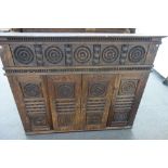 A 19th century French carved oak Breton cabinet with a pair of sliding doors and extensive bobbin