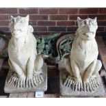 A pair of 20th century Gothic Revival seated griffins/grotesques, 34cm wide x 60cm high.