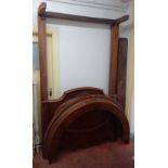 A Victorian figured walnut half tester bed, with bow canopy and curved footboard,