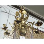 A Dutch brass six branch chandelier, 17th century, the bulbous stem issuing six scroll branches,