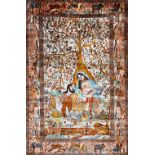 A fine Indian silk pictorial rug, depicting a couple resting under a flowering tree,