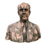 A patinated terracotta bust, late 20th century, depicting a middle aged gentleman in a blazer,