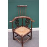 A George III and later ash and elm double height corner chair, on square supports,