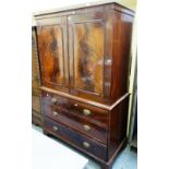 A George III mahogany linen press, the pair of panel doors over two short and two long drawers,
