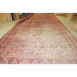 An Usbek carpet, the madder field an all over medallion design, five roundels,