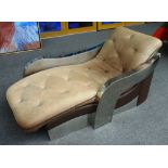 A 20th century chrome framed tub back chaise-longue with brown leather upholstery,