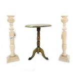 A pair of early 20th century turned and carved ivory candlesticks,