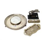 A silver shaped rectangular twin handled small dressing table tray, having embossed decoration,