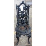 Probably Coalbrookdale; a Victorian black painted cast iron garden chair, 42cm wide x 100cm high,