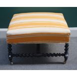 A 19th French square footstool on ebonised barleytwist supports, 70cm wide x 40cm high.