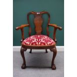 A George II style walnut scroll vase back armchair with bow seat on claw and ball feet,