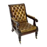 An early 19th century mahogany reclining open armchair with integral foot rest and studded green