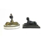 A Victorian patinated bronze desk weight modelled as a sphinx, 14cm wide,