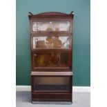 The Lebus Bookcase; a 20th century oak stepped glazed four section bookcase,