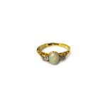 A gold, opal and diamond set three stone ring,