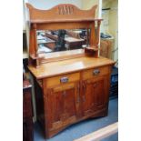 An Arts and Crafts oak mirror back dresser, with pair of drawers over cupboards, 122cm wide x 177cm.