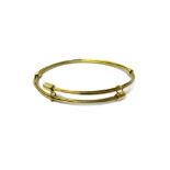 A gold bangle by Links of London, in a multiple wirework oval sprung design, detailed 750,