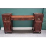 A George IV mahogany pedestal sideboard with three central bow drawers,