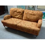 GP & J. BAKER; a 20th century sofa on three turned front supports, 183cm wide x 77cm high.